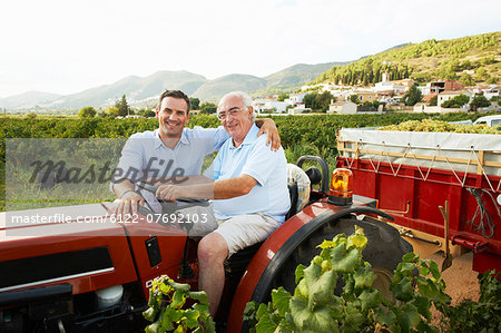 Father and son sitting on tractor