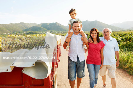 Generational family walking in vineyard
