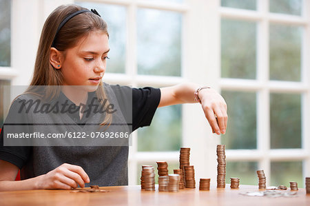 Girl counting piles of money