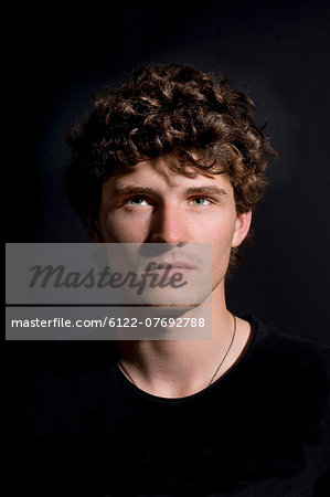 Portrait young man black background