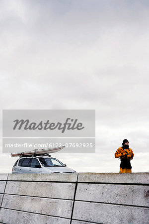 Man infront of car with kayak