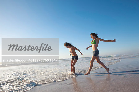 Two girls running on beach