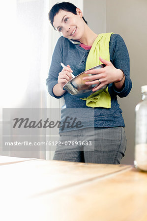 Woman cooking whilst on phone