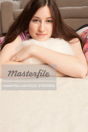 portrait of teenage girl lying on sofa