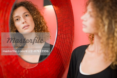 Woman looking at herself in mirror