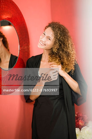 Woman standing in front of mirror