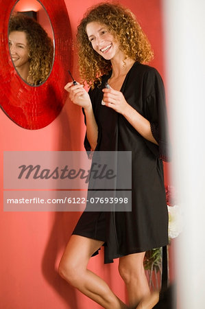 Woman doing her make up in mirror