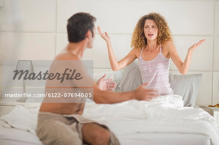 Couple arguing in bedroom Couple arguing in bedroom
