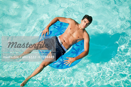 Man on inflatable ring in pool