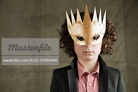 Young boy wearing gold crown mask