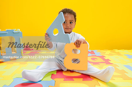 Baby boy playing with toy alphabet letters