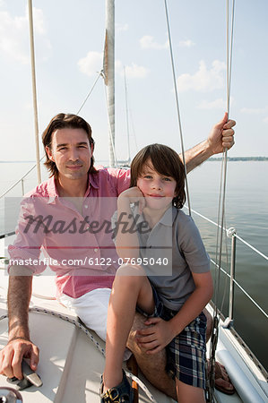 Father and son on board yacht, portrait