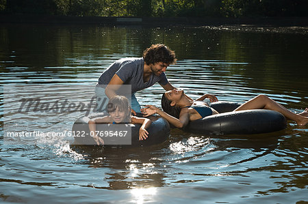 Couple and daughter having fun in lake
