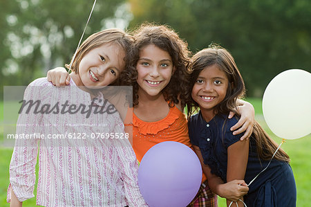 Girls at birthday party holding balloons