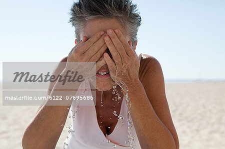 Senior woman washing face