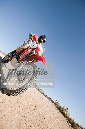 Man riding dirt bike on dirt track