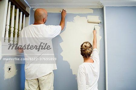 Couple painting wall