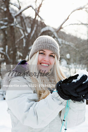Mid adult woman playing in snow