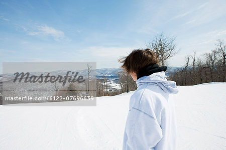 Young man wearing hooded top looking away