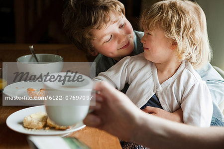 Brother and sister having breakfast