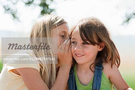 Girl whispering to firiend