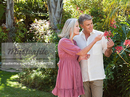 Couple looking at flowers in garden