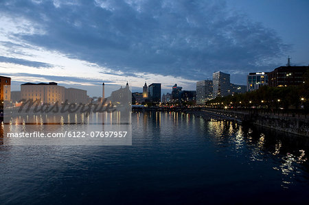 Sunset over waterfront out to Albert Dock and city skyline, Liverpool, UK