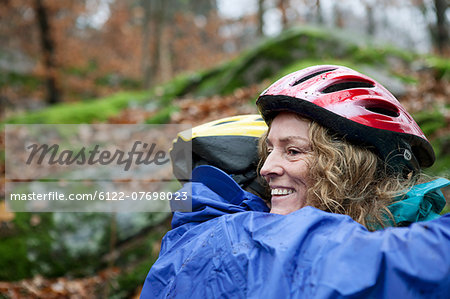 Mature couple wearing cycling helmets and embracing