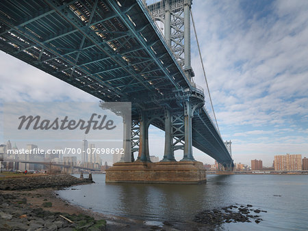 View of Manhattan from under the Manhattan Bridge, from Main Street Park in winter, New York City, New York, USA