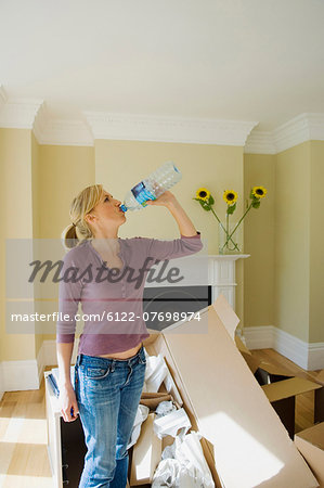 Woman drinking water in new home