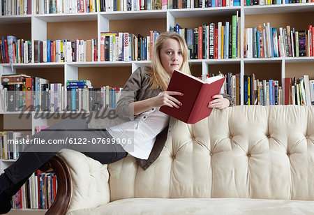 Girl reading on couch in library