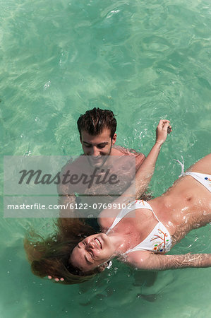 Couple playing in tropical sea