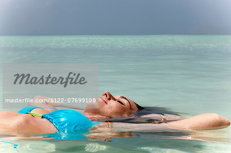 Woman floating in tropical sea