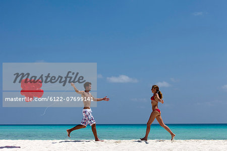 Couple running to each other on beach