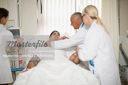 Doctors and nurse tending to patient