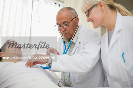 Doctors tending to hospital patient