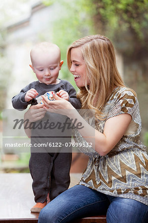 Woman playing with toddler son