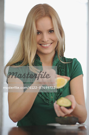 Smiling woman eating at table