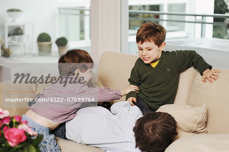 Boys playing on the sofa