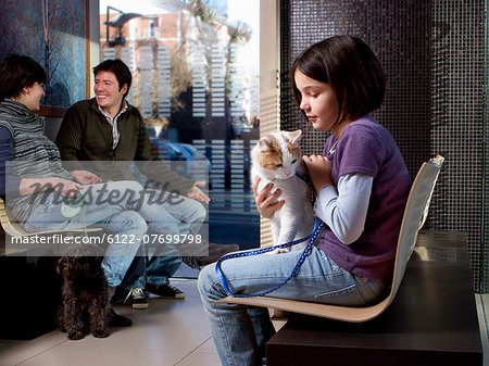 Girl with her cat in vet waiting room