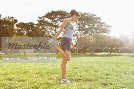 Runner stretching in field