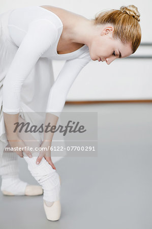 Ballet dancer examining hurt ankle