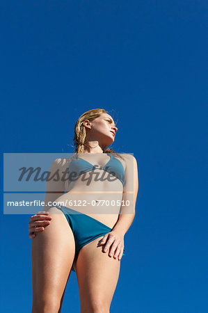 Woman wearing bikini against blue sky