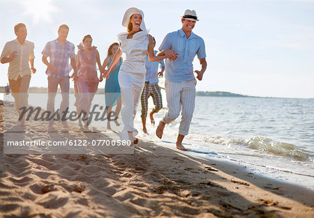 Newlywed couple on beach with friends