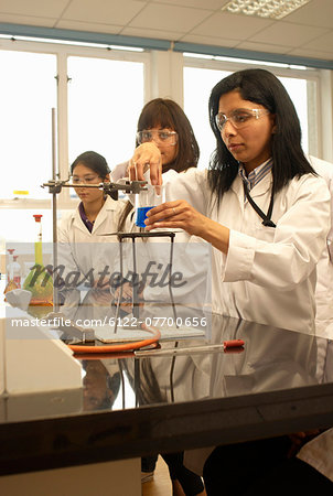 Scientist heating liquid in beaker