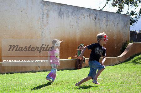 Brother and sister playing in backyard