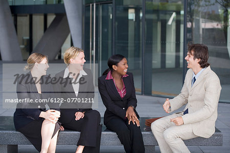 Business people talking on bench