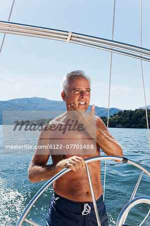 Older man sailing on lake