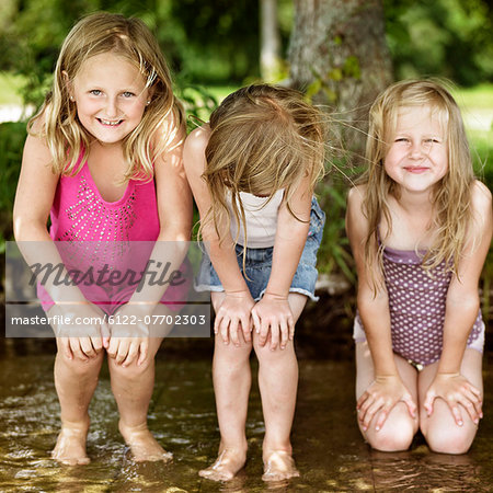 Smiling girls playing in lake