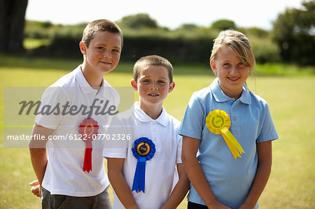 Children wearing ribbons in field